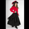 Woman wearing red shirt, black skirt and black hat.