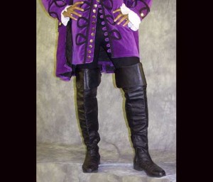 Lower half of a man wearing a purple Rennaissance coat and black boots.